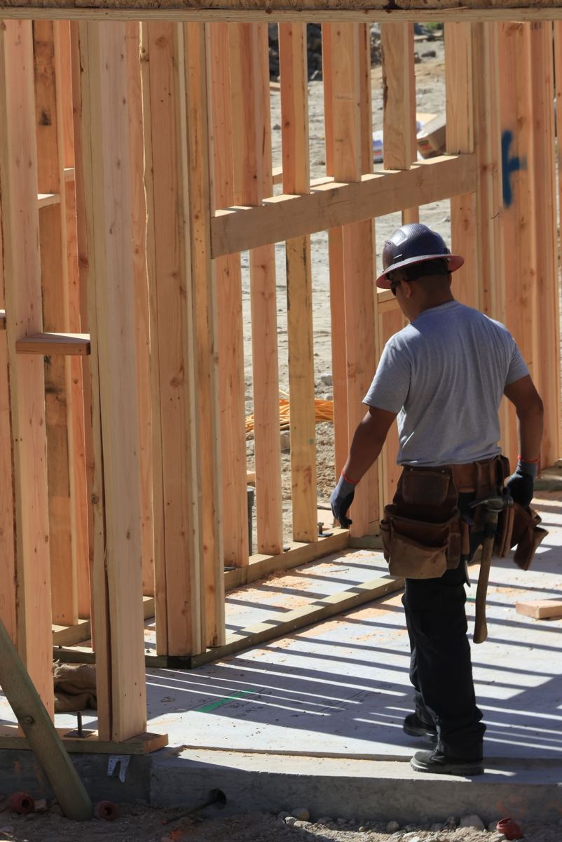 Worker with a tool belt on a framing site